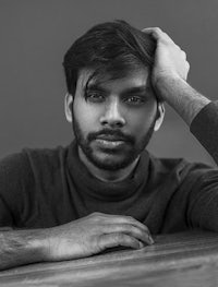 a black and white photo of a man with a beard